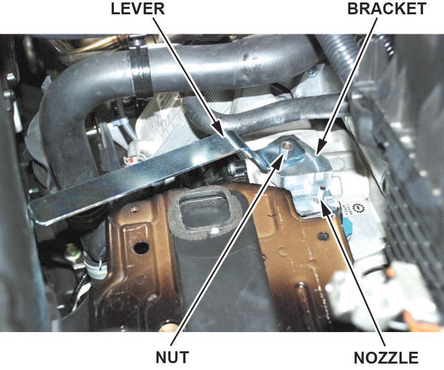 Remove the nut, handle, bracket, and nozzle from the vehicle